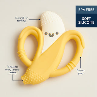 Itzy Ritzy Chew Crew® - Banana Yellow and white silicone teething toy shaped like a banana on a beige background