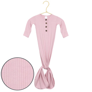 Lou Lou and Company Ribbed Knotted Gown - Haven
Pink baby onesie with buttons on a hanger against a white background