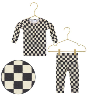 Lou Lou and Company Top and Bottoms - Gibson
Black and white checkered shirt and pants on hangers with a circular view of the pattern.