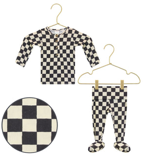 Lou Lou and Company Top and Bottoms - Gibson
Black and white checkered shirt and pants on hangers with a round checkered item below.