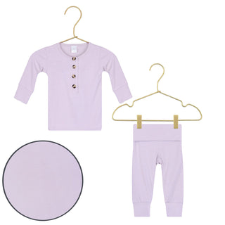 Lou Lou and Company Top and Bottoms - Isabelle
Lavender baby outfit with shirt and pants on hangers against a white background