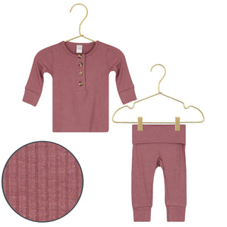 Lou Lou and Company Top and Bottoms - Marjorie
Baby outfit with long-sleeve shirt and pants on hangers with close-up of fabric texture.