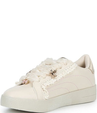 Steve Madden Kid's Emora Sneaker - Cream
An off-white low-top sneaker featuring a decorative ruffled lace strap across the front, delicate floral embellishments, and a chunky platform sole, shown against a plain white background.