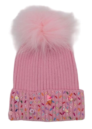 Bari Lynn Sprinkle Treat Cuff Beanie with Fur Pom - Pink
Pink knit beanie with colorful embroidered pattern and fluffy pink pom-pom on a light gray background