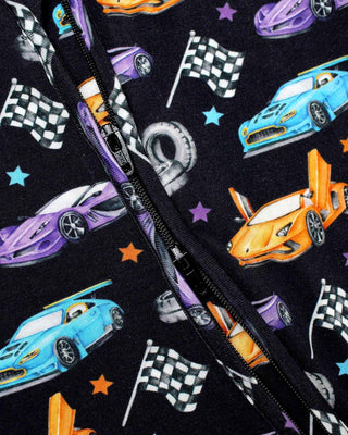 Lev Baby Zippered Footie - Elias
Close-up of a zipper with race car and flag pattern on a black background