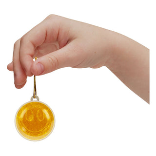 Nee Doh Squishmas 2025 Advent Calendar
Hand holding a round yellow pendant with a white background