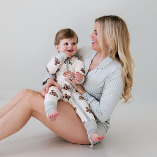 In My Jammers Zipper Romper - Cruisin Teddy
Woman holding a baby against a plain background
