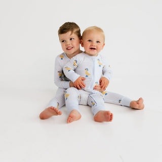 In My Jammers Zipper Romper - Striped Ducks
Two children wearing matching pajamas sitting on a white background