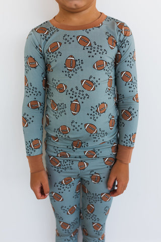 In My Jammers Green Football Two Piece Set
Child wearing a blue pajama set with football pattern on a white background