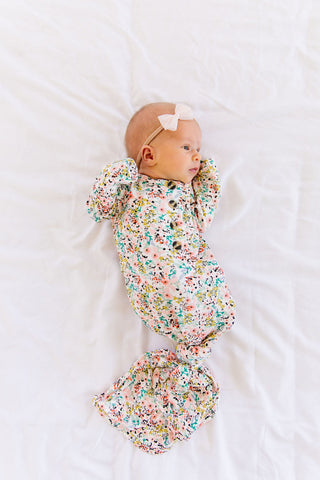 Lou Lou and Company Knotted Gown - Millie
Baby swaddled in a floral blanket with a white background