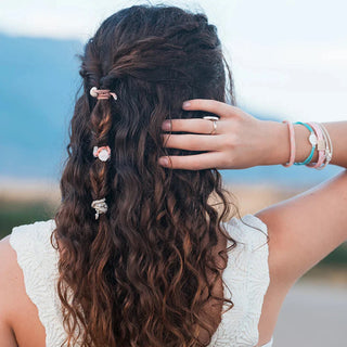 K'lani "Shimmer" Coral with Shell Hair Tie Bracelets
Woman with braided hair and decorative hairpins, blurred natural background