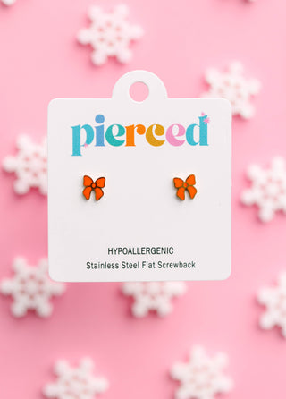 Pierced Co. Red Bow Earrings
Pair of orange butterfly earrings on a 'pierced' branded card with a pink background