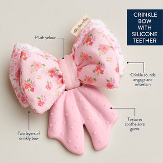 Itzy Ritzy Bow Teensy Crinkle™ teether for babies, featuring colorful crinkle fabric and a bow design for sensory exploration.