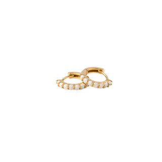 Pip Pop Post Earrings - Opal Hoop
A pair of small gold huggie hoop earrings adorned with delicate rows of white round pearls, set against a solid white background.