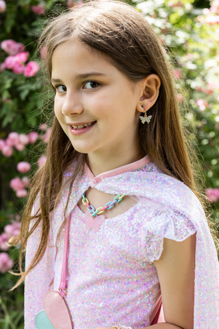 Great Pretenders Kaleidoscope Butterfly Necklace
Young girl in a pink dress with a floral background
