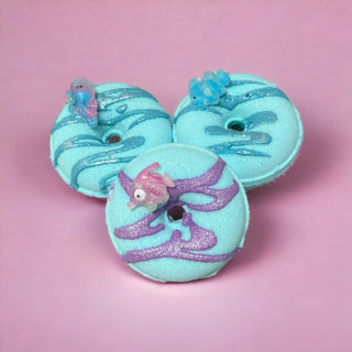 The Lavish Goat Ocean Breeze Bath & Body Donut Prize Bath Bomb with blue and white swirling design.