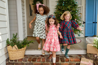 Pink Chicken Girls Stevie Dress - Vintage Trees
Three young girls in dresses running on a porch with a Christmas tree in the background.