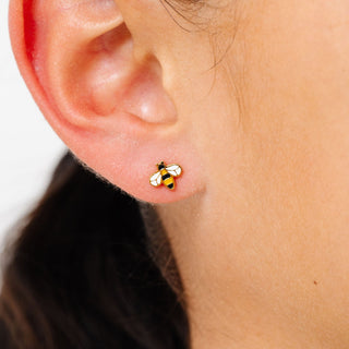 Pip Pop Post Earrings - Bee
Close-up of an ear wearing a bee-shaped stud earring.