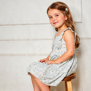 Makemake Organics organic flutter buttoned tiered dress in ivy floral pattern, featuring a flowy design and tiered layers.