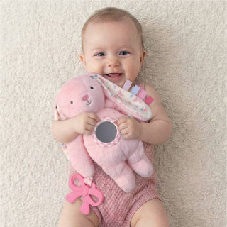 Itzy Ritzy Bitzy Traveler™ - Pink Bunny
Baby holding a pink plush toy on a beige carpet