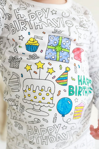 Caden Lane Colorable Two Piece Pajama Set featuring birthday celebration design for kids, soft fabric and playful pattern.