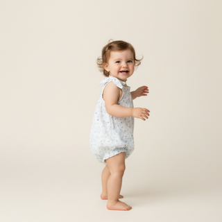 Makemake Organics organic tie shoulder bubble romper in ivy floral print, lightweight and comfortable for warm weather.