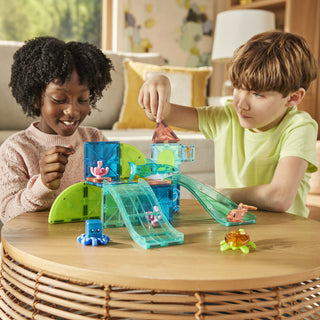 Magna-Tiles Coral Reef™ 25-Piece Set
Two children playing with a toy set on a wooden table in a living room.