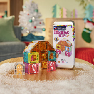 Magna-Tiles microMAGS Gingerbread House 24-Piece Travel Set
Colorful magnetic building blocks and a gingerbread house-themed packaging on a table with a festive background.