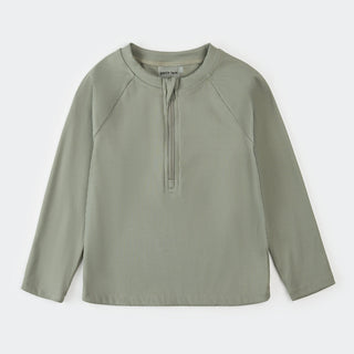 Petit Lem ribbed sage half zip rashguard for kids, showing the swimwear with a half zip front and ribbed texture in sage green.