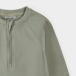 Petit Lem ribbed sage half-zip rashguard swimwear for kids, featuring a textured fabric and half-zip front design.