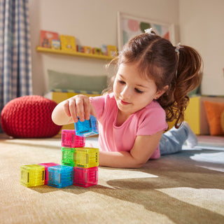 Magna-Tiles microMAGS Cubes 9-Piece Set
Child playing with colorful building blocks on a carpeted floor.