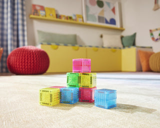 Magna-Tiles microMAGS Cubes 9-Piece Set
Colorful building blocks on a carpeted floor with a child's room in the background