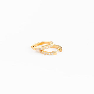 Pip Pop Post "Diamond" Gold Hoops
Gold ring with embedded stones on a white background