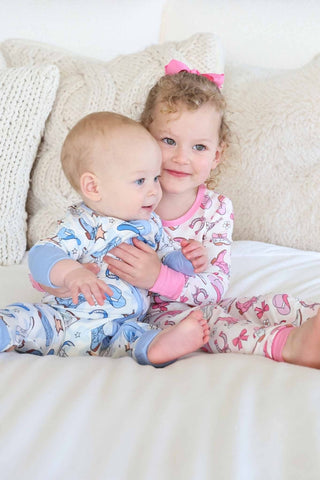 Caden Lane Rodeo Dreams Pink two-piece pajama set for girls with playful rodeo print and soft fabric, perfect for bedtime.