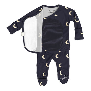 Bonsie Footie - G'night Moon
A baby footed sleeper set consisting of a navy blue long-sleeve top and matching pants with a gold crescent moon pattern, shown with an open front zipper revealing a white fleece lining. The brand name 'BonnieB' is visible on the inner collar and on the leg.