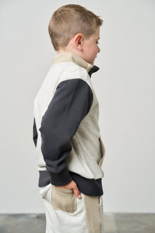 Little Bipsy Colorblock Mockneck Pullover - Stone Grey
Child wearing a two-tone jacket with a plain background