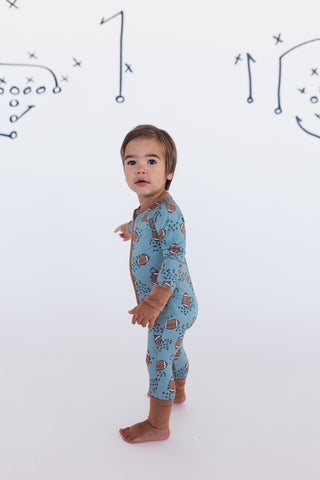 In My Jammers Green Football Zipper Romper
Child wearing a blue onesie with animal pattern on a white background