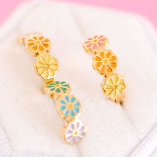 Pierced Co. Colorful Daisy Huggies
Colorful floral earrings on a white and pink gradient background