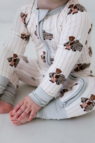 In My Jammers Zipper Romper - Cruisin Teddy
Baby wearing a onesie with teddy bear and car patterns on a light background