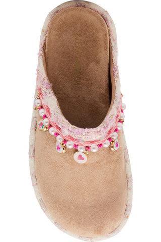 Steve Madden Kid's Leigh Slip-On - Taupe
A single women's slip-on mule shoe in light beige suede, decorated with a pink floral lace trim, faux pearls, and dangling pink and gold heart charms, shown against a plain white background.