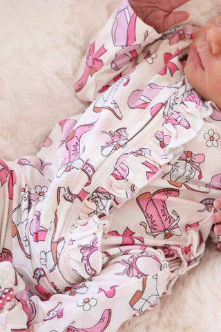 Caden Lane Rodeo Dreams Pink ruffle zipper footie for babies, soft pink fabric with ruffle details and front zipper closure.
