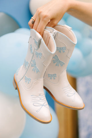 Wild & Rae baby blue cowgirl boots with bows, stylish Western ankle boots for girls with decorative buckle and stitching details.