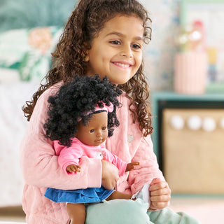 Corolle Maelys 14" Doll
Young girl holding a doll with curly hair, wearing a pink outfit.