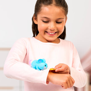 Little Live Pets™ NeeDees™ - Candy Series
Young girl wearing a blue toy on her wrist with a white background