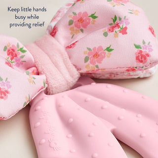 Itzy Ritzy Bow Teensy Crinkle™ baby teether in soft pastel colors with crinkle texture and bow design for sensory play.