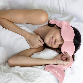 Noppod Weighted Sleep Eye Mask - Blush
Person wearing a pink sleep mask in bed