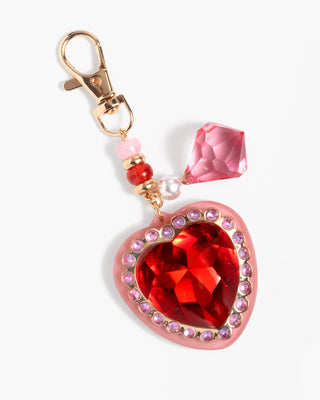 Super Smalls Royal Heart Bag Charm
Heart-shaped keychain with red gemstone and pink crystal on a white background