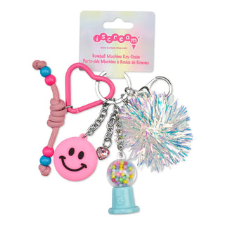 Iscream Gumball Machine Bag Charm
A pink and multicolor bombshell machine key ornament set by iScram, featuring a pink heart-shaped carabiner, pink smiley face charm, beaded cord, iridescent bombshell pom-pom, and a miniature gumball machine charm, shown with its original packaging card on a white background.
