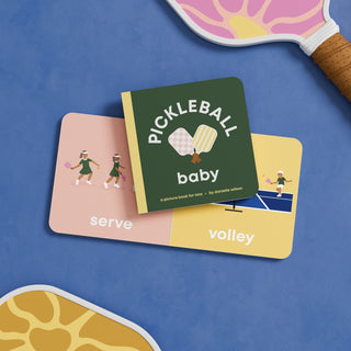 Left Hand Book House Pickleball Baby board book showing colorful illustrations of a baby playing pickleball.