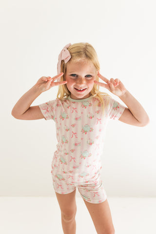 In My Jammers Two Piece Short Set - Tea Party
Young girl wearing a floral pajama set with a white background